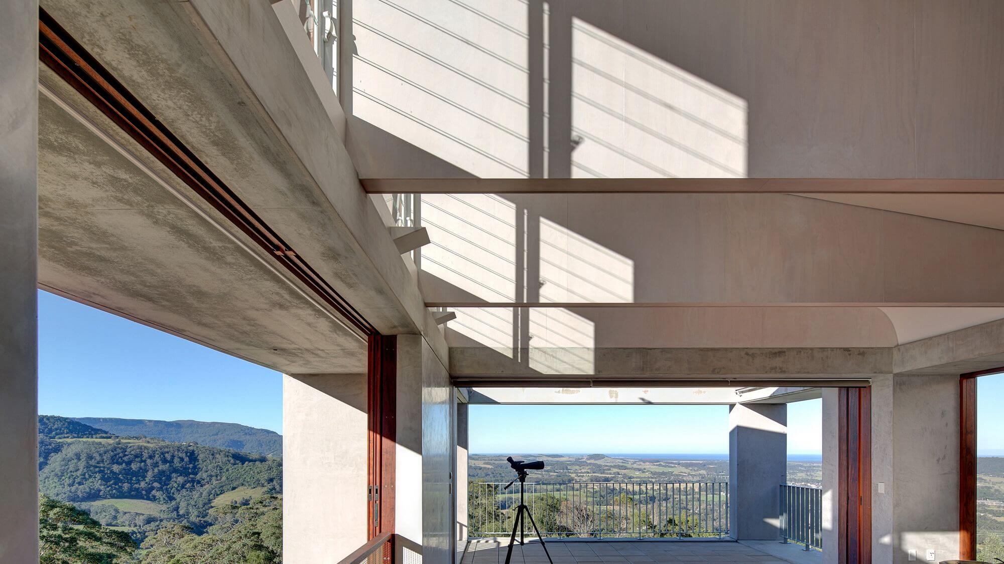 A scenic view from a living room showcasing majestic mountains in the background