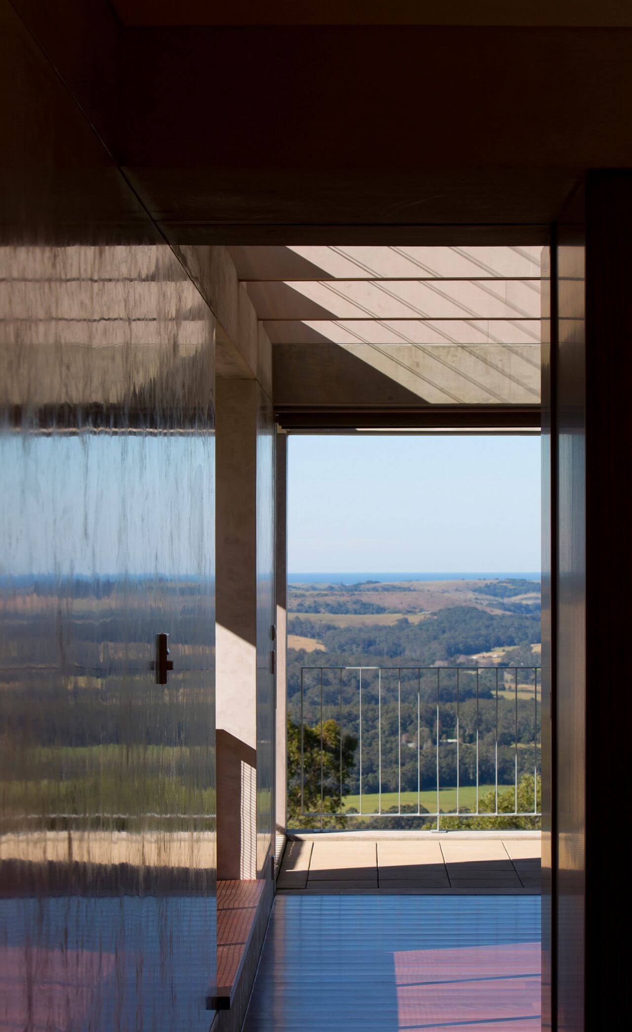 A serene view of the ocean visible through a window from the comfort of a home interior
