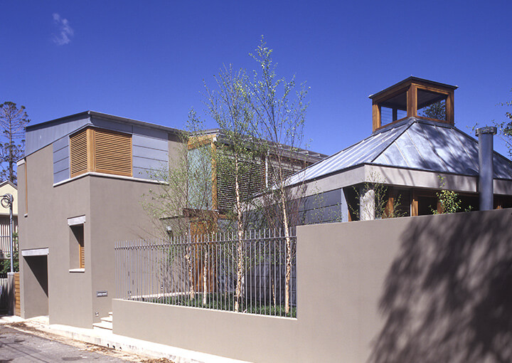 A wooden fence encircles a charming house
