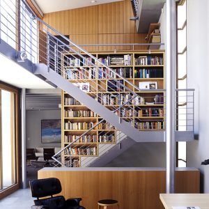 Stylish living room showcasing a staircase alongside a plush chair