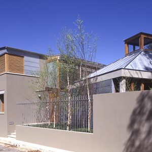 A well-maintained fence encloses a lovely house
