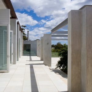 A serene walkway lined with elegant columns, offering a clear view.