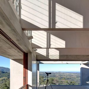 A scenic view from a living room showcasing majestic mountains in the background