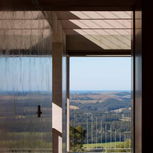 A serene view of the ocean visible through a window from the comfort of a home interior